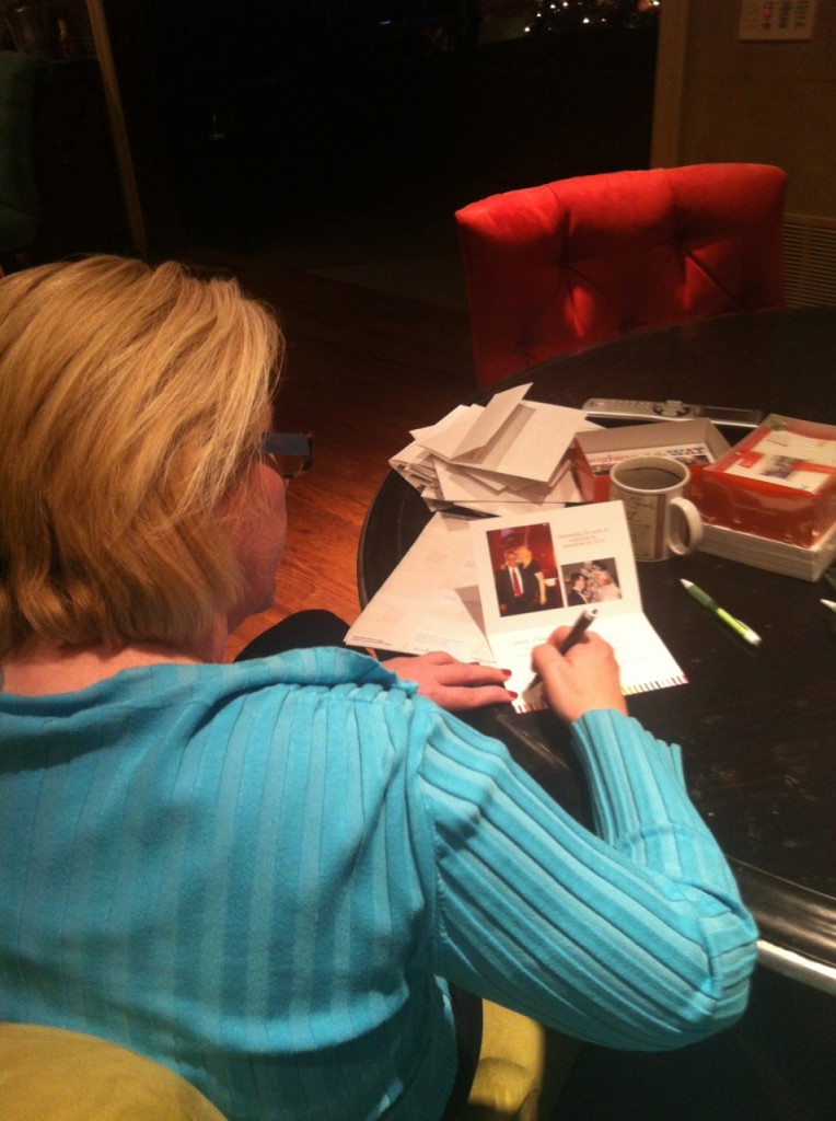 Bonnie McGrath penning a personal note on one of the 800 Christmas cards she sends | juliesaffrin.com