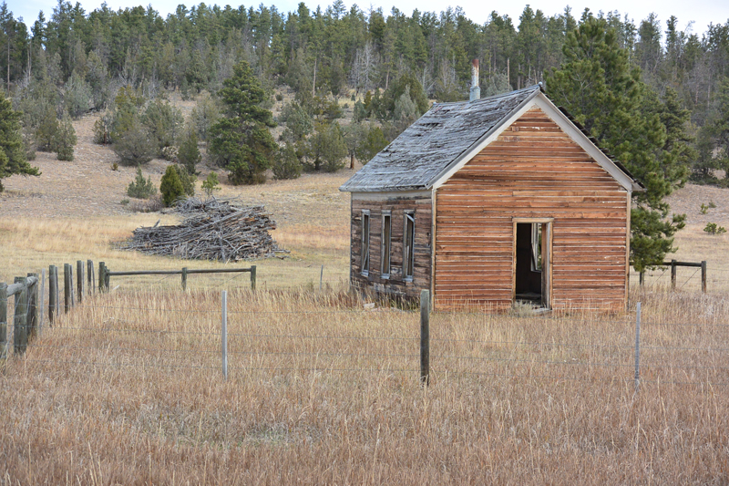 Home on the Wyoming prairie with a slash pile